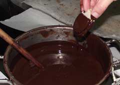 dipping the cookies into melted chocolate