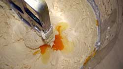 adding eggs to the creamed butter
