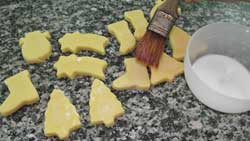 brushing the raw cookies with milk