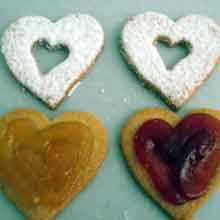 filling almond cookies with jam