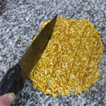 slicing the almond brittle in to strips