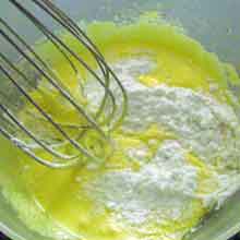 adding flour to the pastry cream