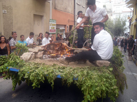 carnival float with an open fire roasting meat at the wine festival