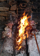 meat roasting on an open fire