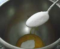 adding sugar to the egg yolks