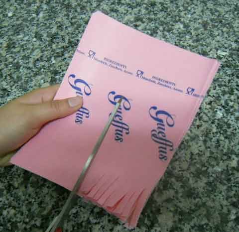 cutting the paper to wrap the almond cookies in