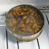 almonds in a pan of boiling water