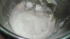 adding flour to the biscuit dough recipe