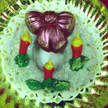 wreath cookie with three iced candle and red bow