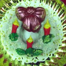 wreath cookie with three iced candle and red bow