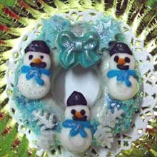 white and blue wreath cookies with mini snowmen