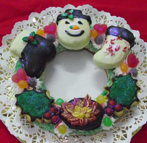 extra large wreath cookie with an assortment of christmas cookies on top